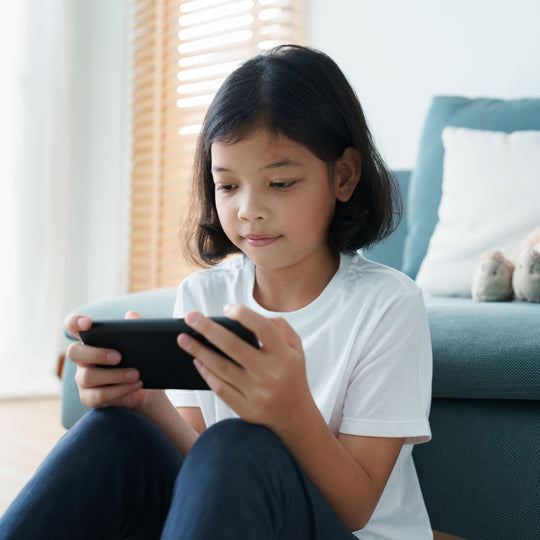 Girl playing on cell phone. internet safety day