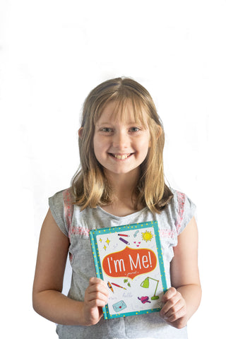 Girl Holding I'm Me! Journal from Hopscotch Girls